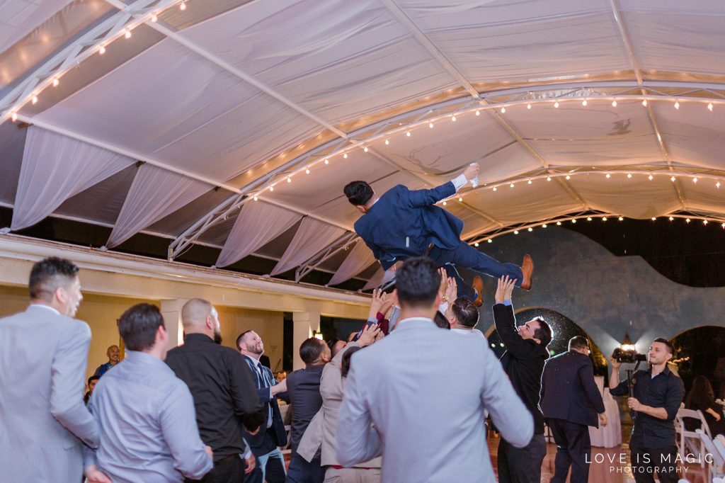 groomsmen throwing groom in the air