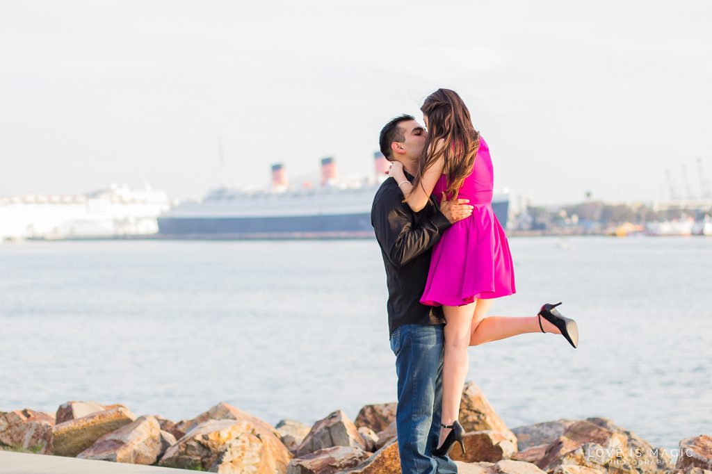 Long Beach engagement couple poses in front of Queen Mary