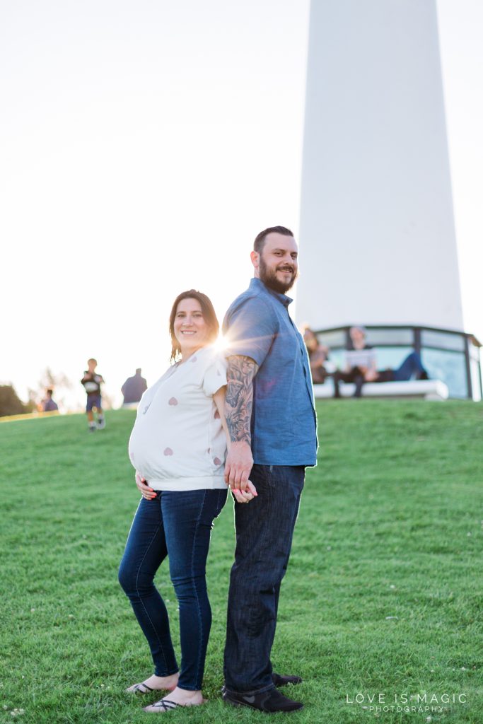Long Beach engagement couple poses in front of lighthouse
