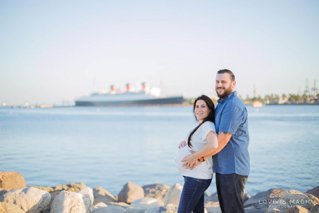 Long Beach maternity couple poses in front of Queen Mary