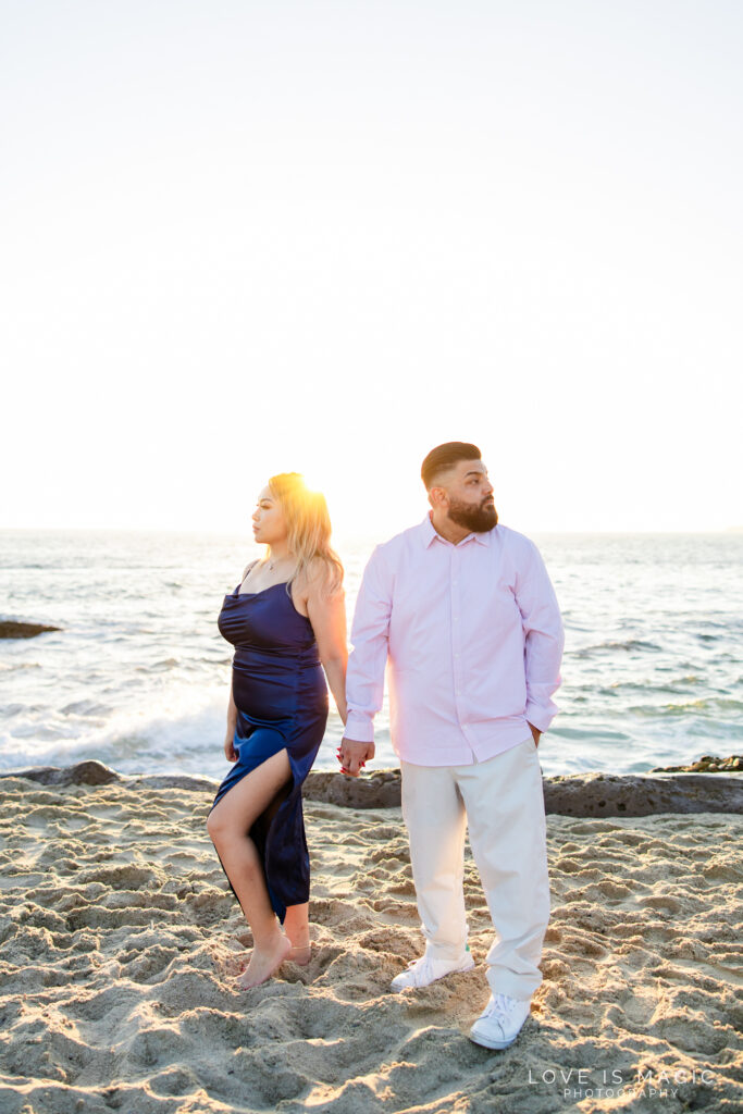 couple holds hands at their Treasure Island Beach engagement session, photo by Love is Magic Photography