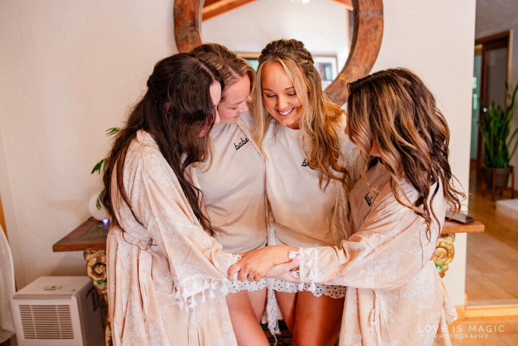 bridesmaids hug while getting ready for Big Sur Elopement