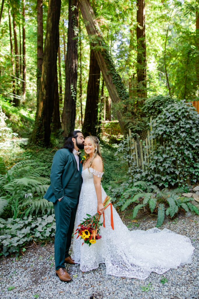 bride and groom kiss in the forest of Big Sur