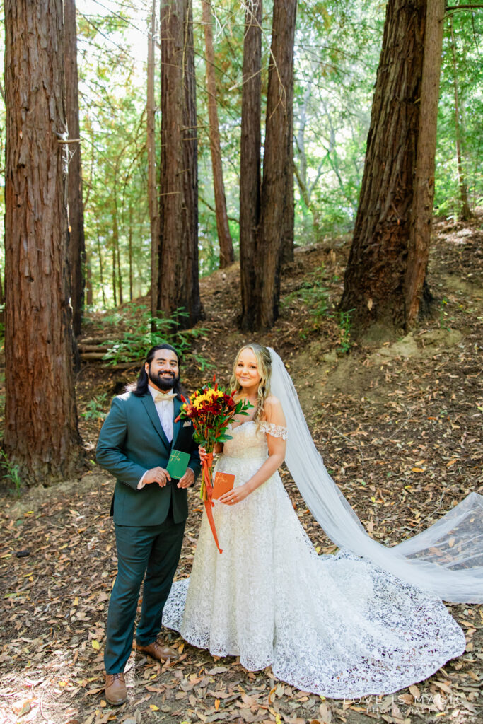 bride and groom hold vow books during their Big Sur Elopement
