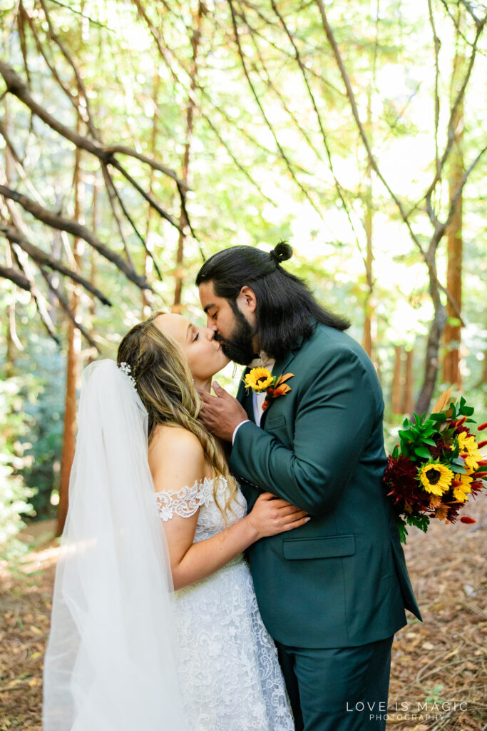 bride and groom kiss in the forest