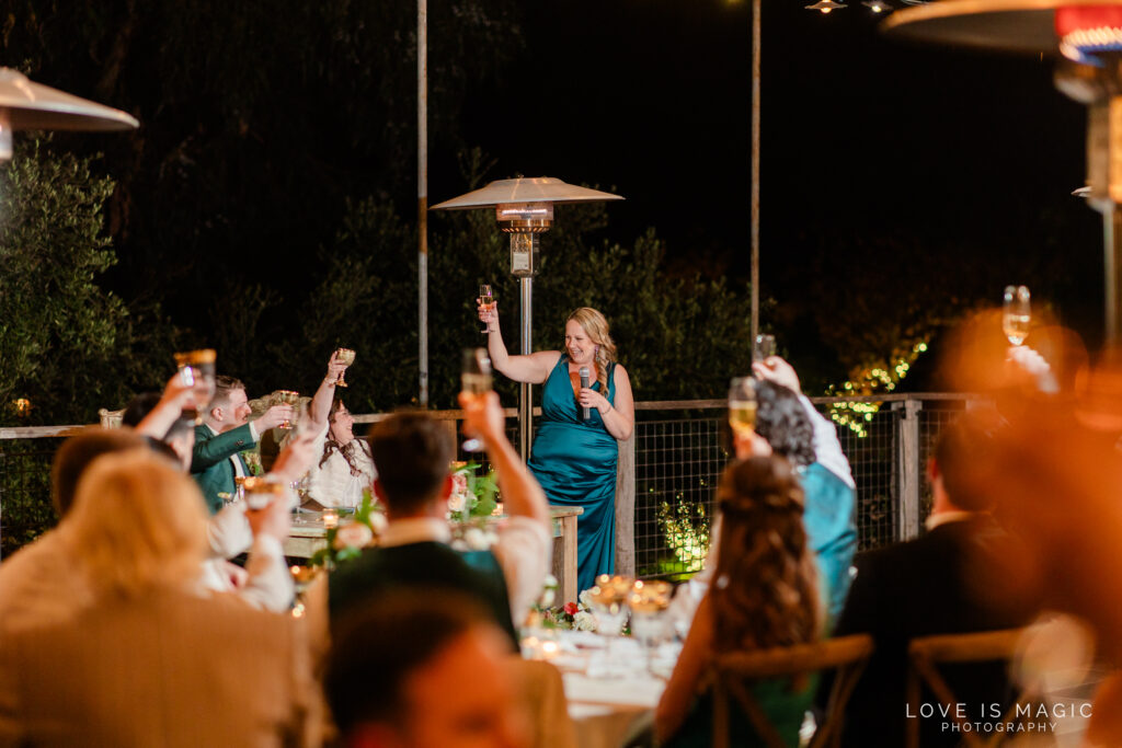 bridesmaid cheers during speech at The Ranch Laguna Beach, photo by Love is Magic Photography