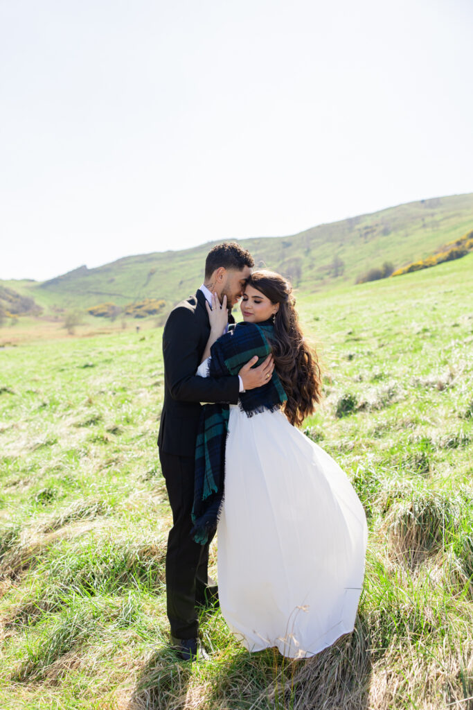 bride and groom hug on Arthur's Seat bride and groom hug on Arthur's Seat