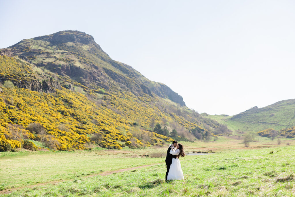bride and groom kissing on Arthur's Seat bride and groom kissing on Arthur's Seat