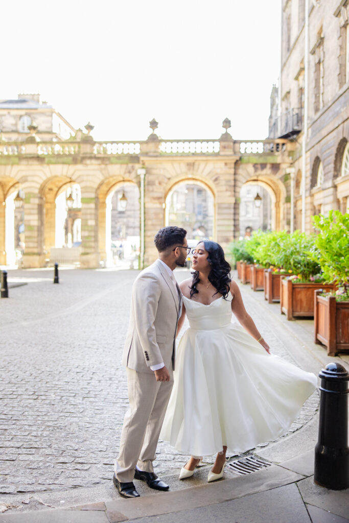 bride and groom kissing in Edinburgh City Chambers courtyard bride and groom kissing in Edinburgh City Chambers courtyard