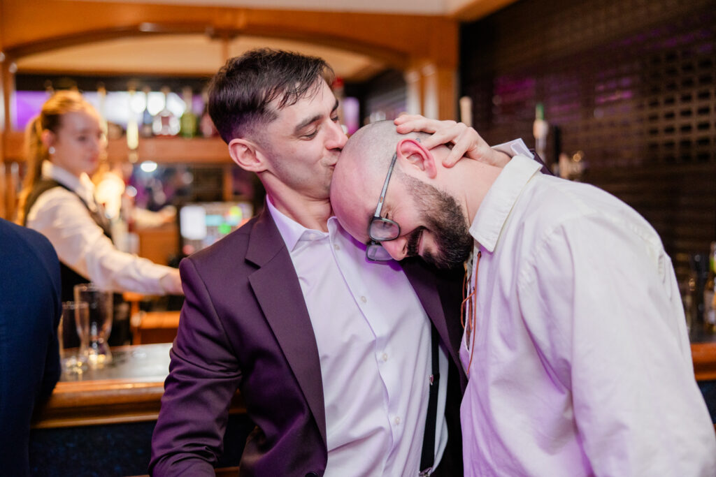 guest kissing grooms shaved head