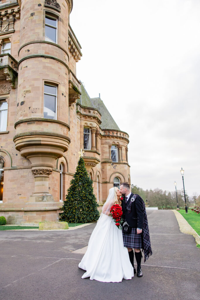Bride and groom outside Cornhill Castle with castle facade in background
