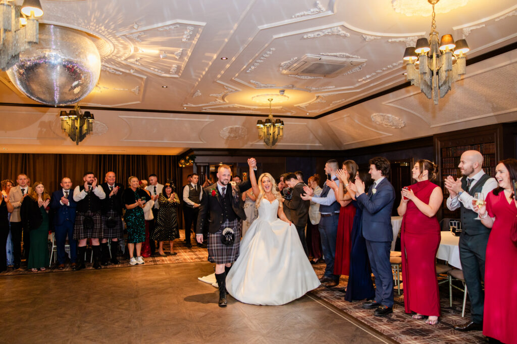 bride and groom entering dance floor