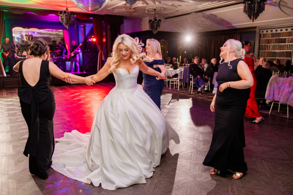 bride dances with guests on wedding day