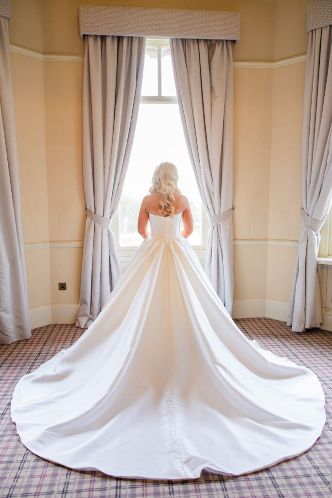 Bride getting ready in Cornhill Castle bridal suite with large windows