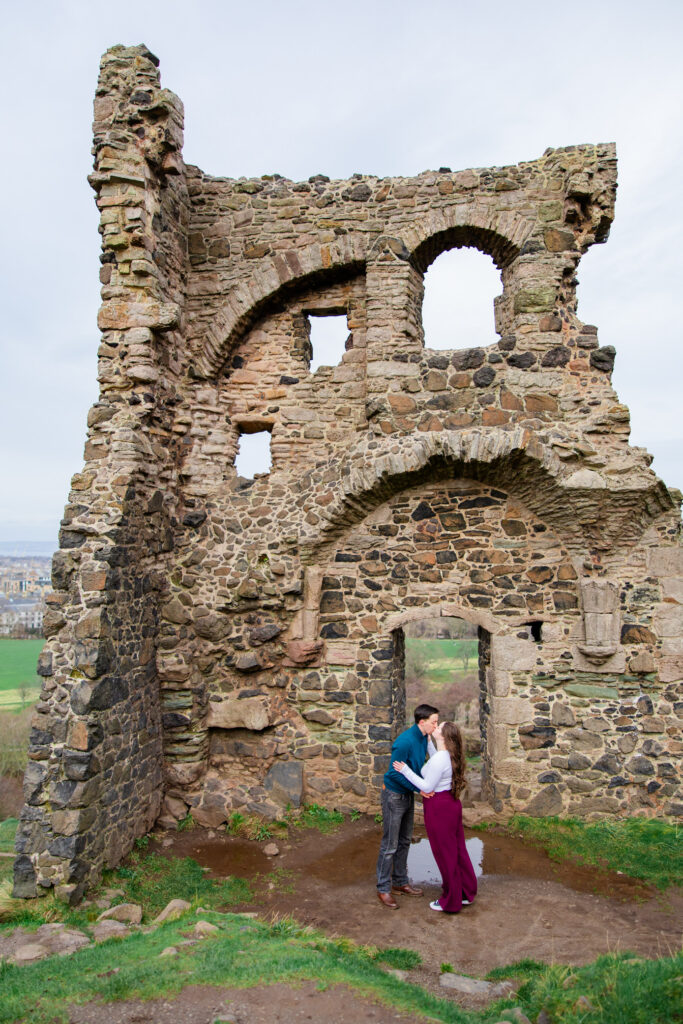 boy and girl running in front of chapel ruins