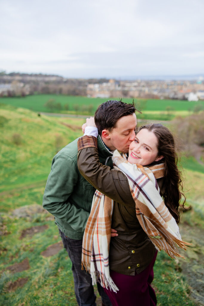 boy kises girl, looking over her shoulder