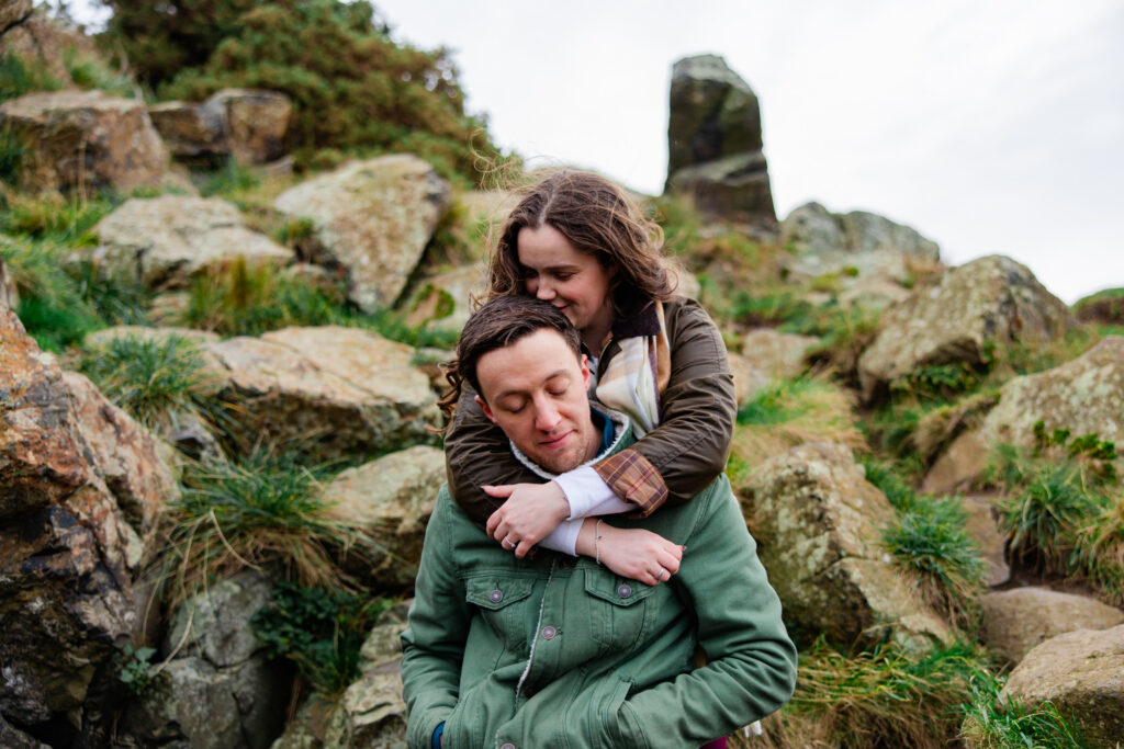 girl hugging boy on a mountain top