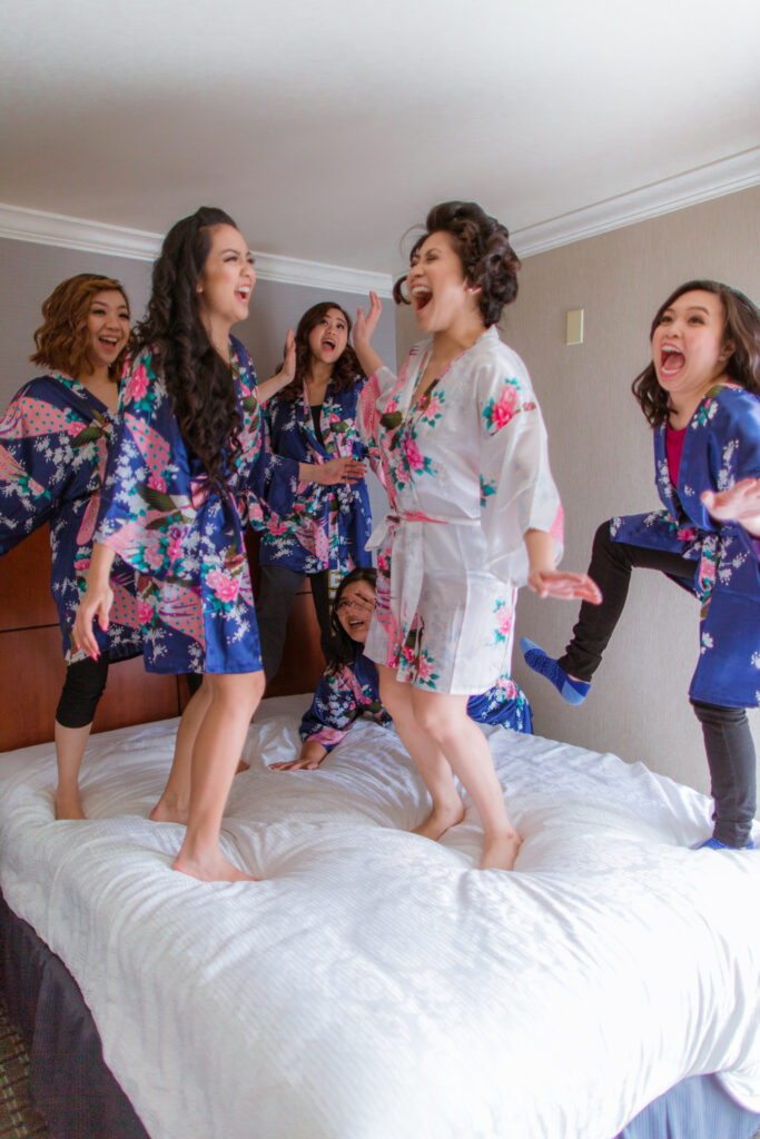 bridesmaids jumping on the bed 