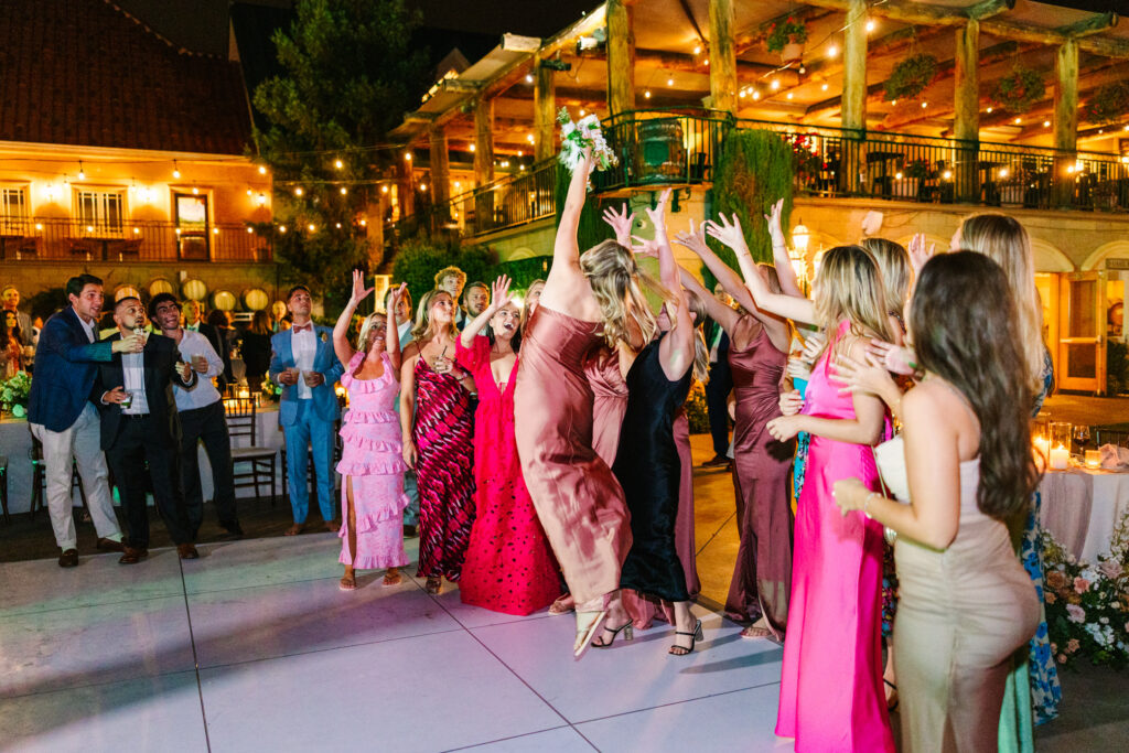 bridesmaid jumps for bouquet 