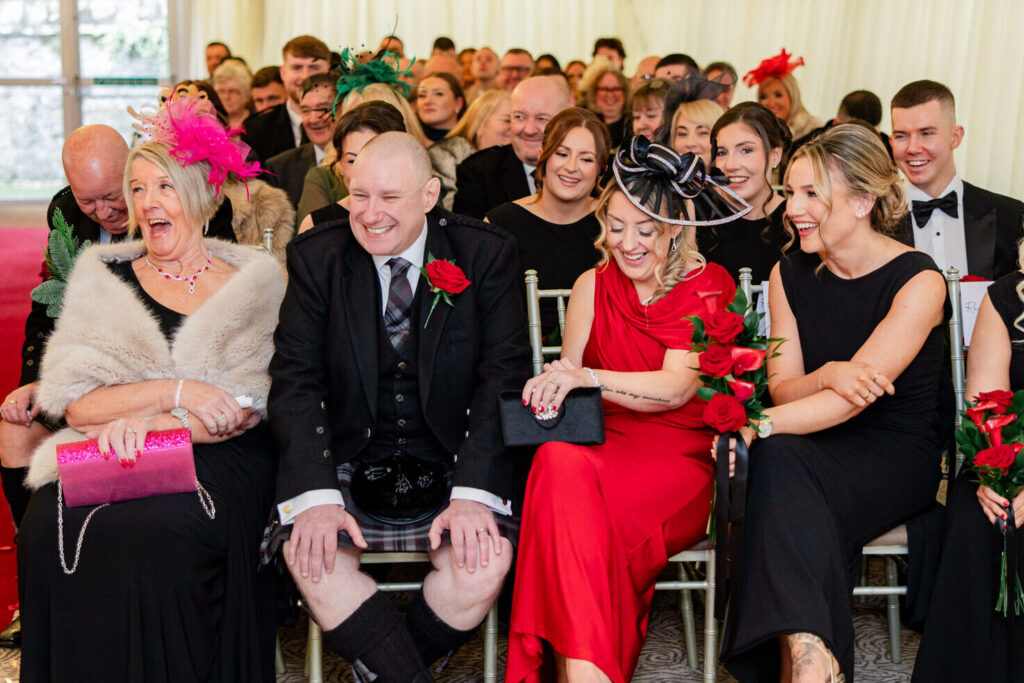 Joyful wedding guests celebrating during an intimate Edinburgh wedding
