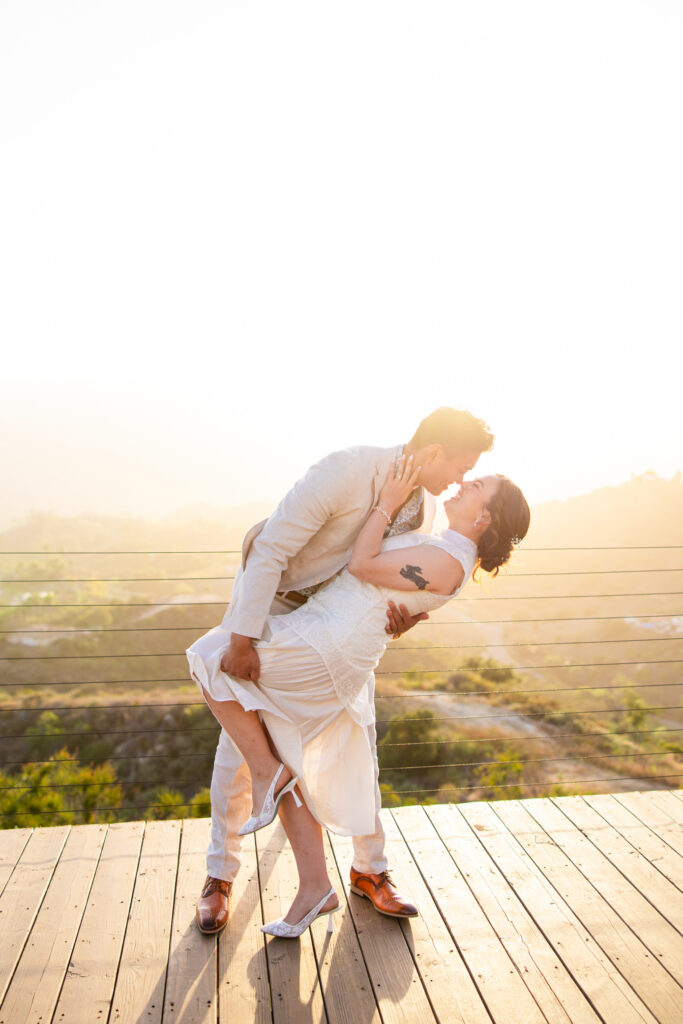bride and groom dip in sunset