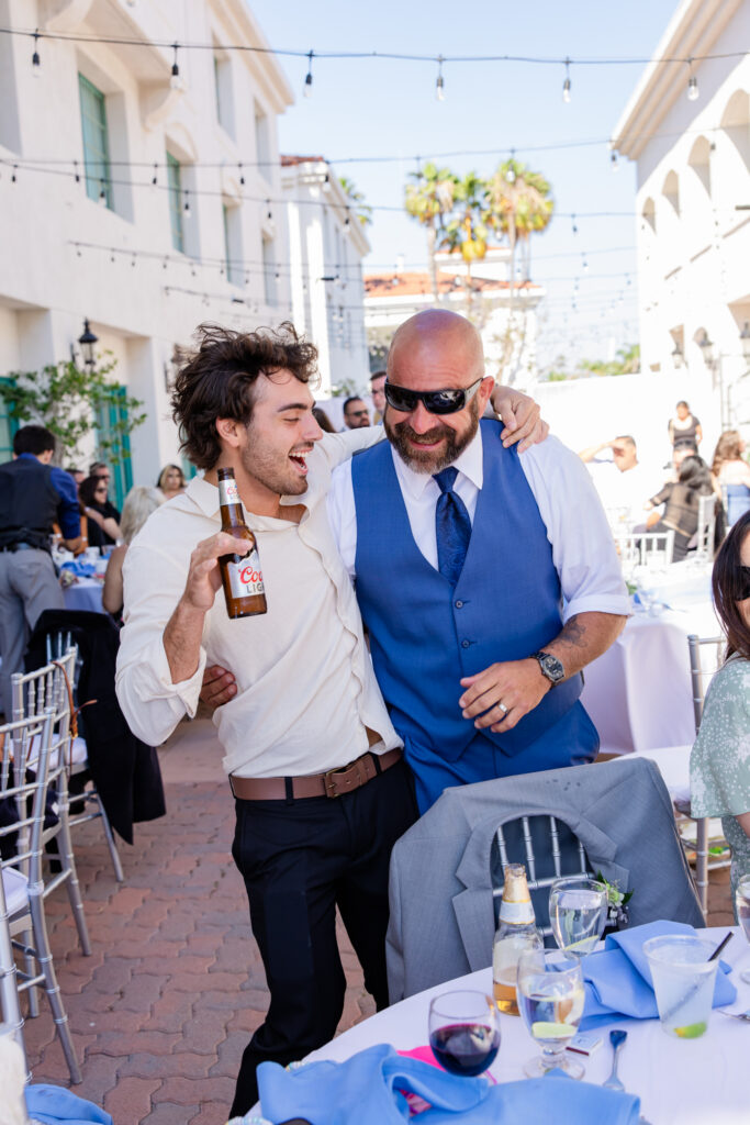Candid wedding photo of guests laughing during speeches