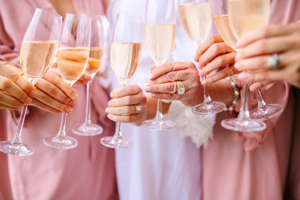 generations of wedding rings holding champagne glasses