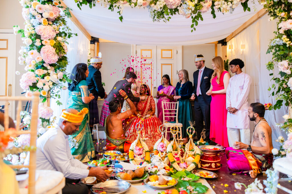 Bride and groom exchanging flower garlands during their Hindu wedding ceremony