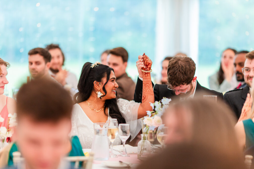 Bride celebrating during heartfelt wedding speeches surrounded by family and friends