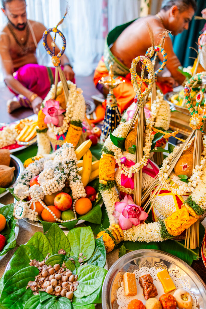 Colourful Hindu wedding ceremony details with floral offerings and ceremonial decorations