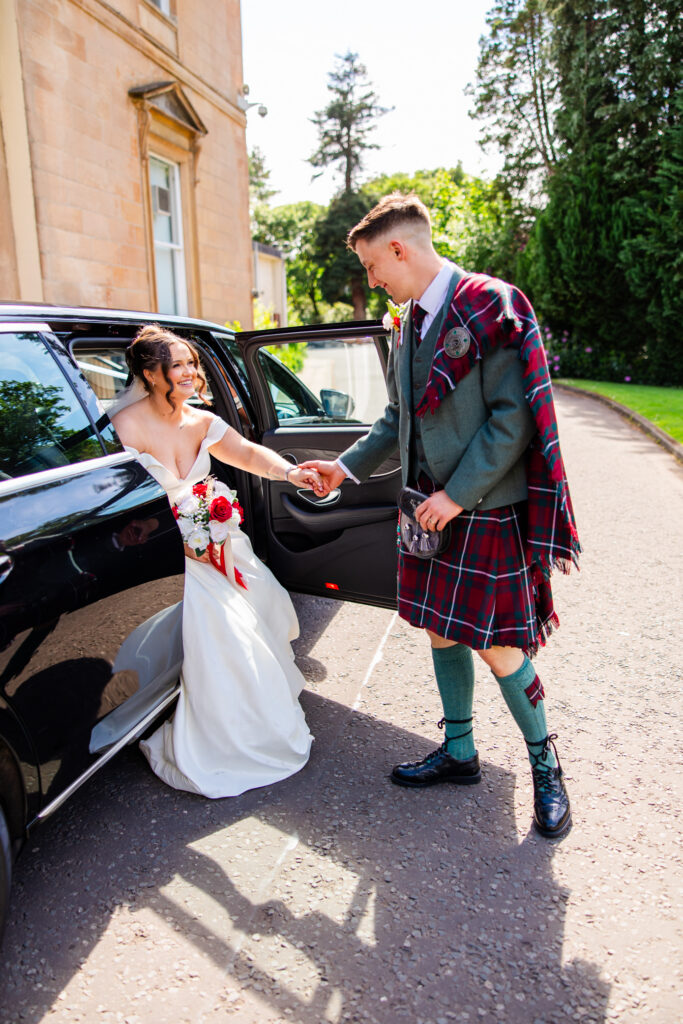 Kilmardinny House groom helps bride from car