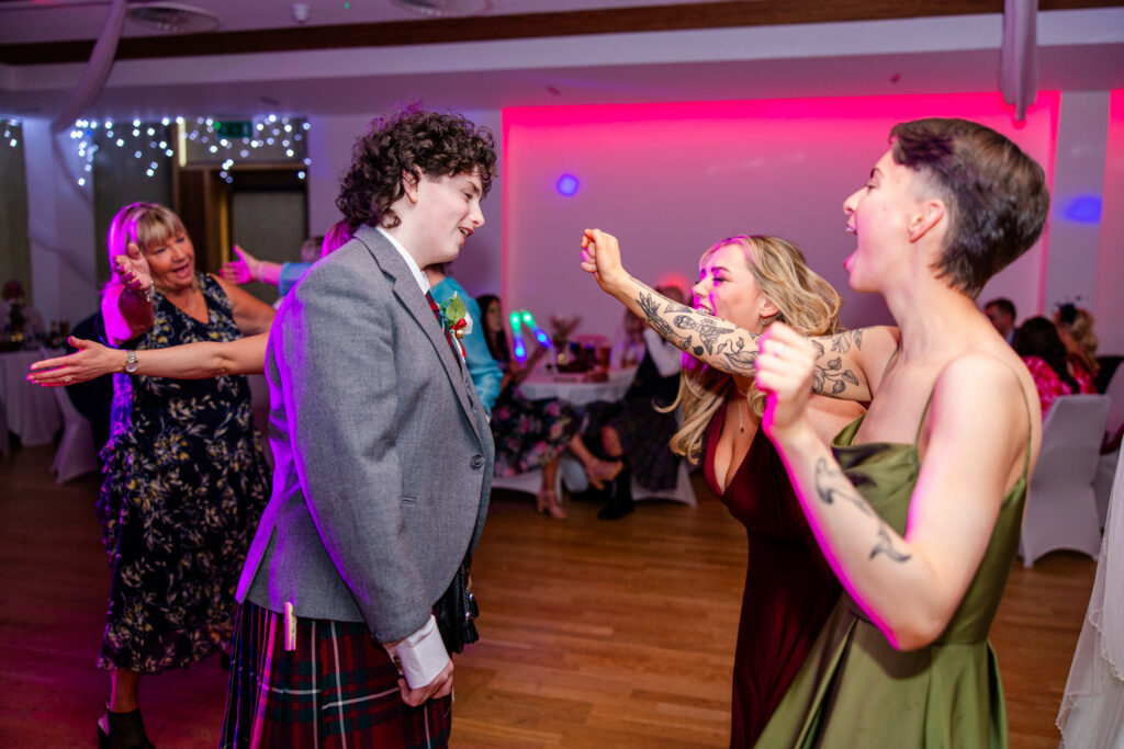 bridesmaids dance with groomsmen