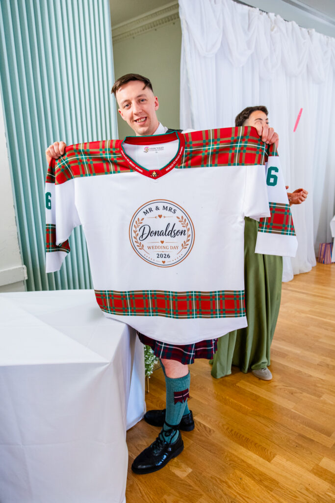 groom holds guestbook