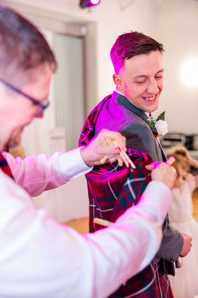 guest removes groom pegs