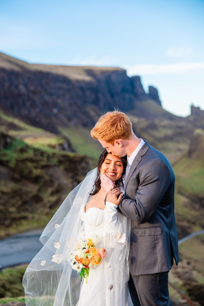 Couple embracing during an intimate Quiraing elopement surrounded by dramatic Highland scenery