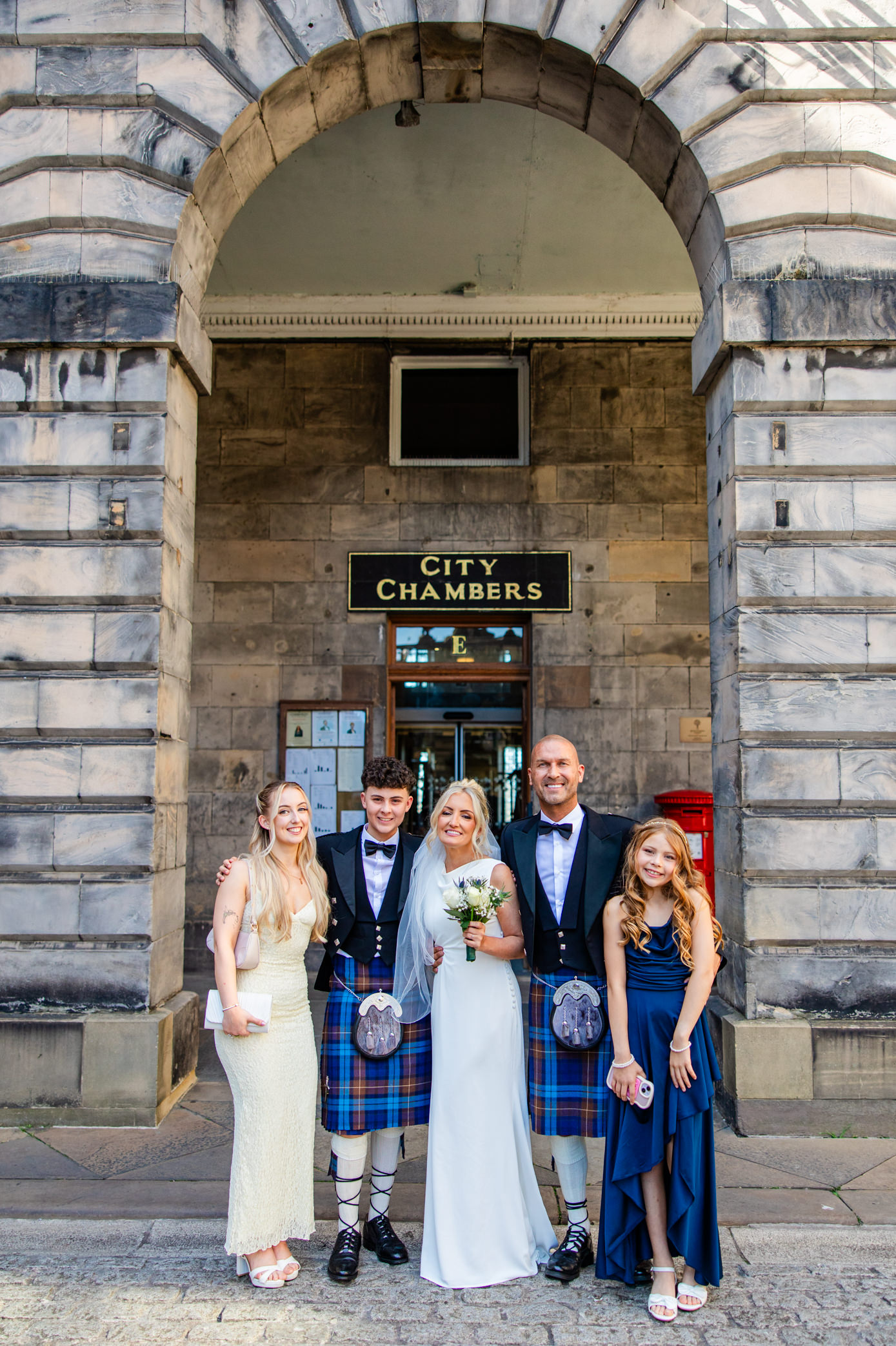 Wedding party posing outside Edinburgh City Chambers after the ceremony
